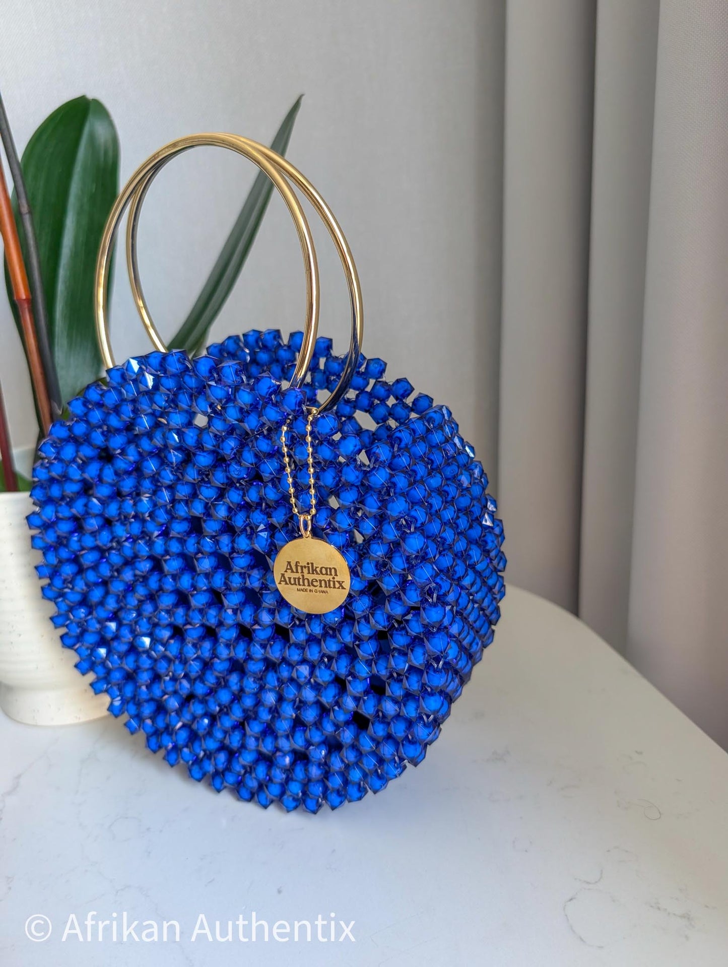 Round blue beaded handbag with gold ring handle handmade in Ghana by Afrikan Authentix