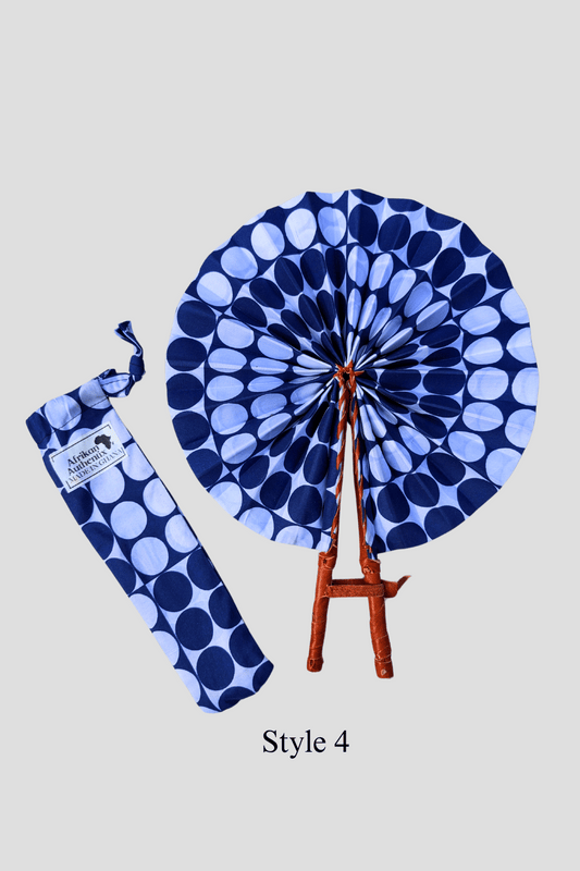 African hand fan with blue polka dot fabric and leather handles, with matching fabric pouch labeled Afrika Authentix