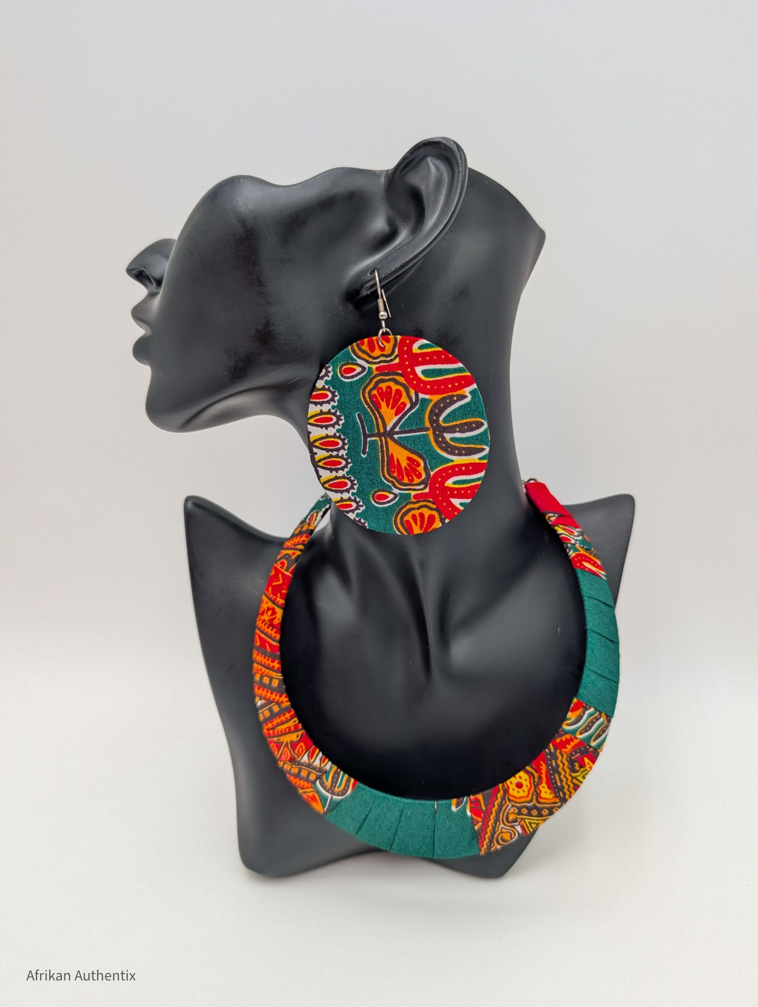 Black mannequin displaying colorful Ankara fabric necklace and matching large round earring