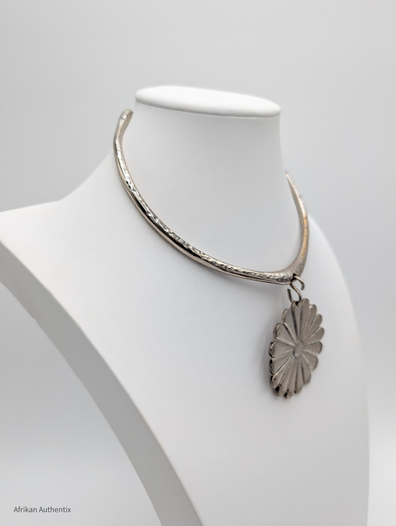 Silver collar necklace with a floral pendant 