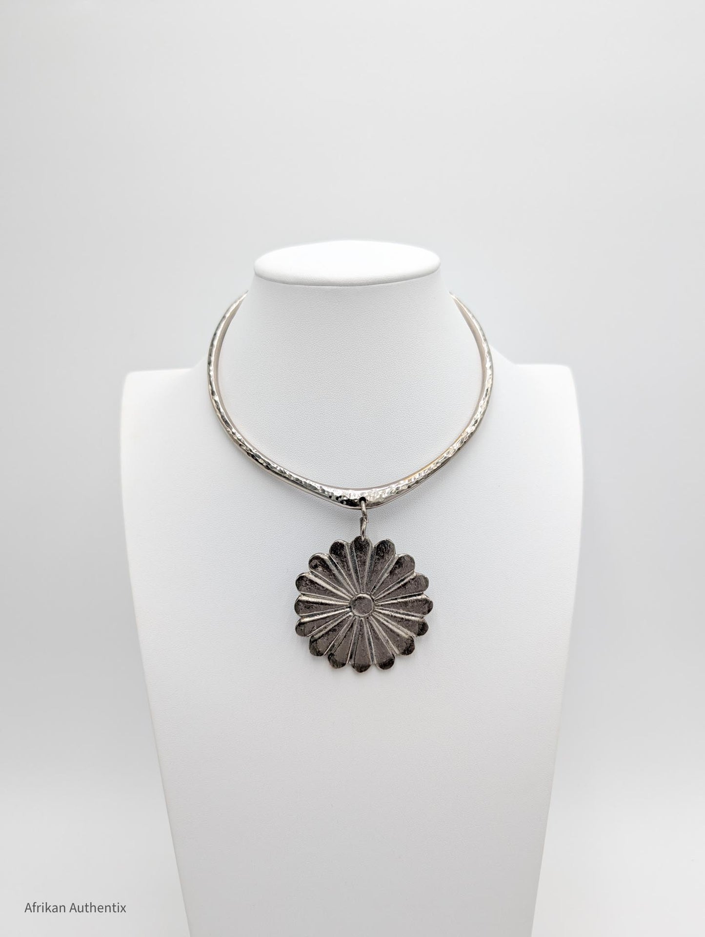 Silver collar necklace with a floral pendant 
