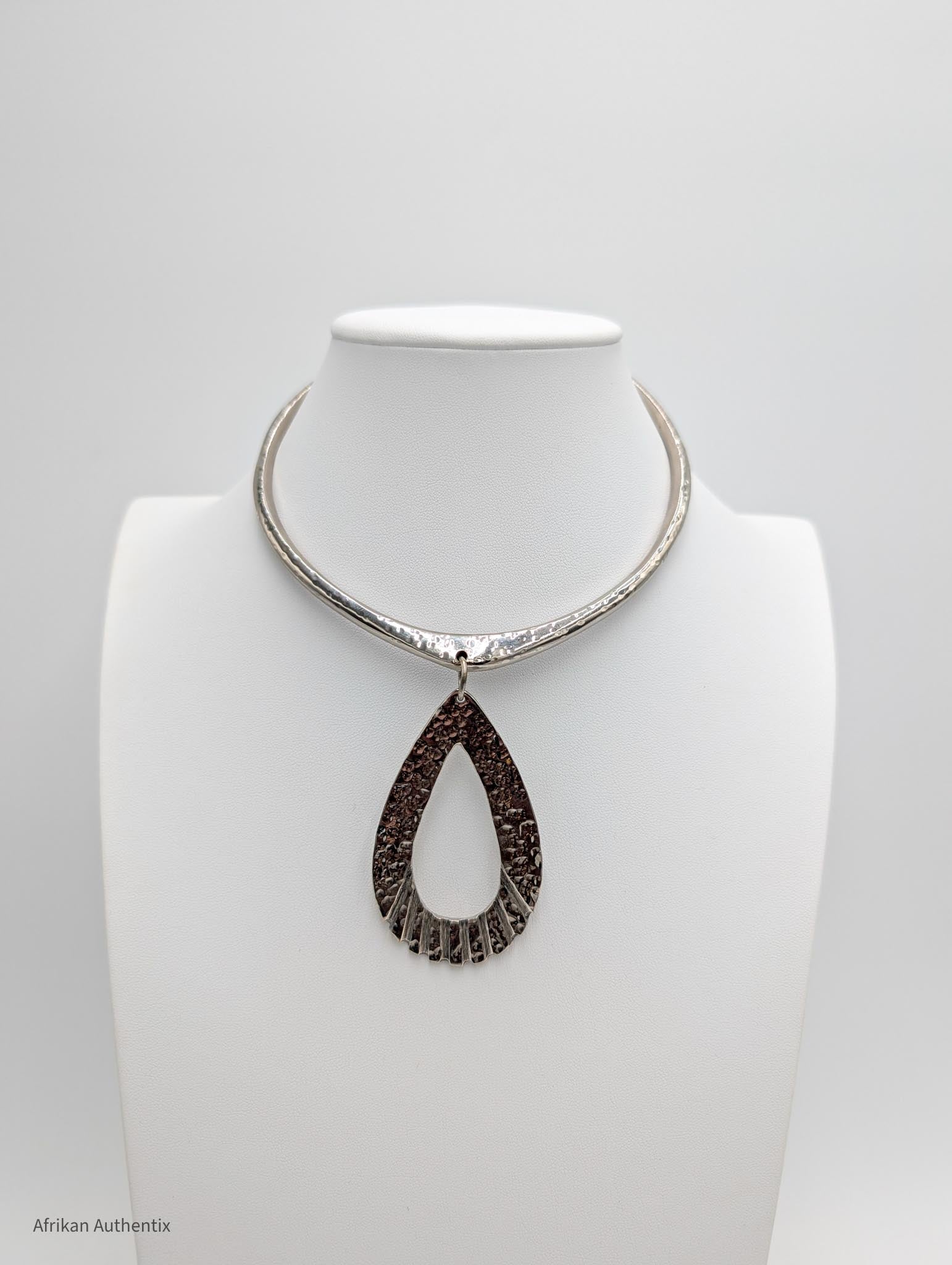 Silver Collar Necklace with a large teardrop-shaped pendant on a mannequin bust against a white background