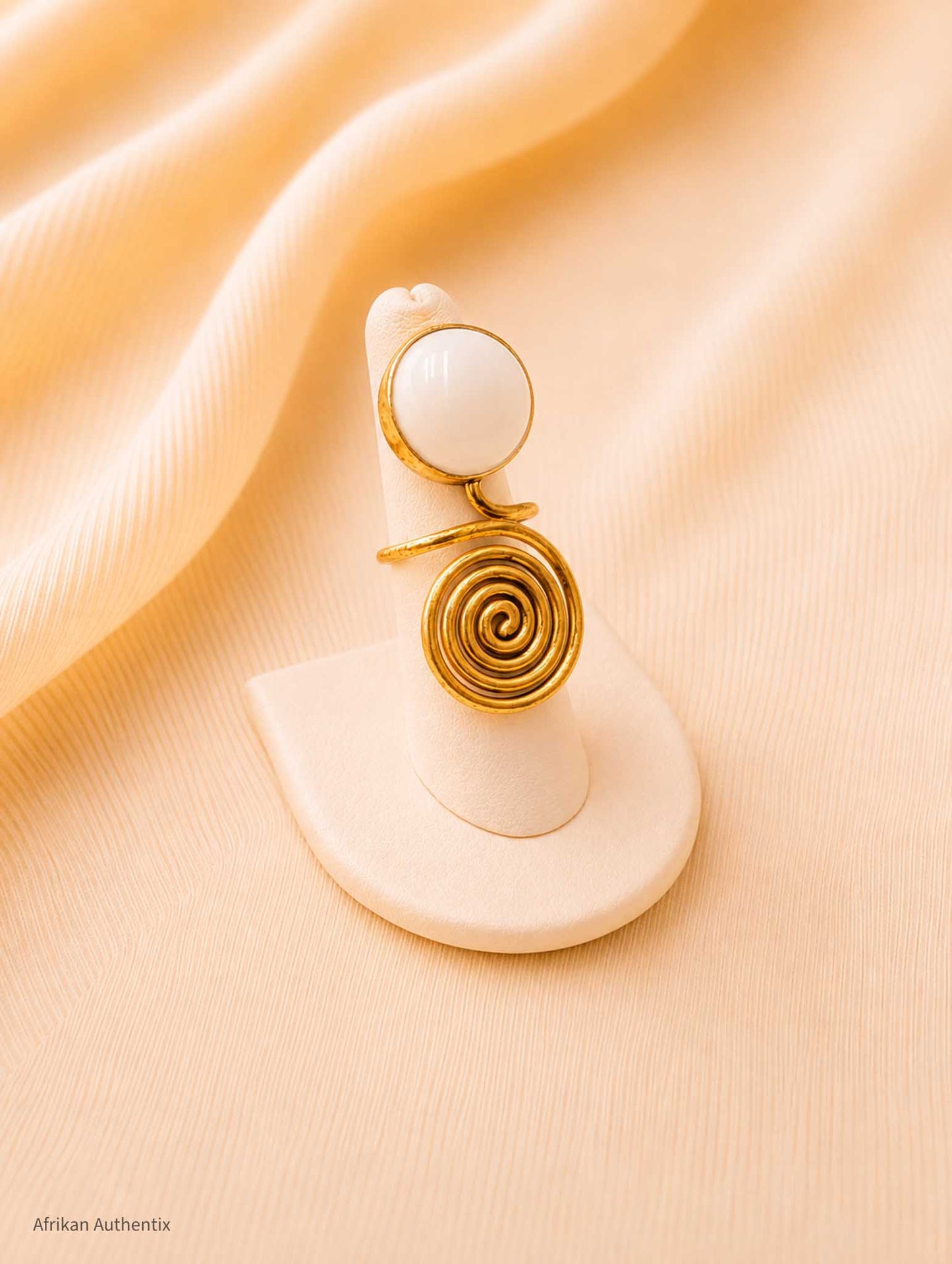 Brass and white spiral ring
