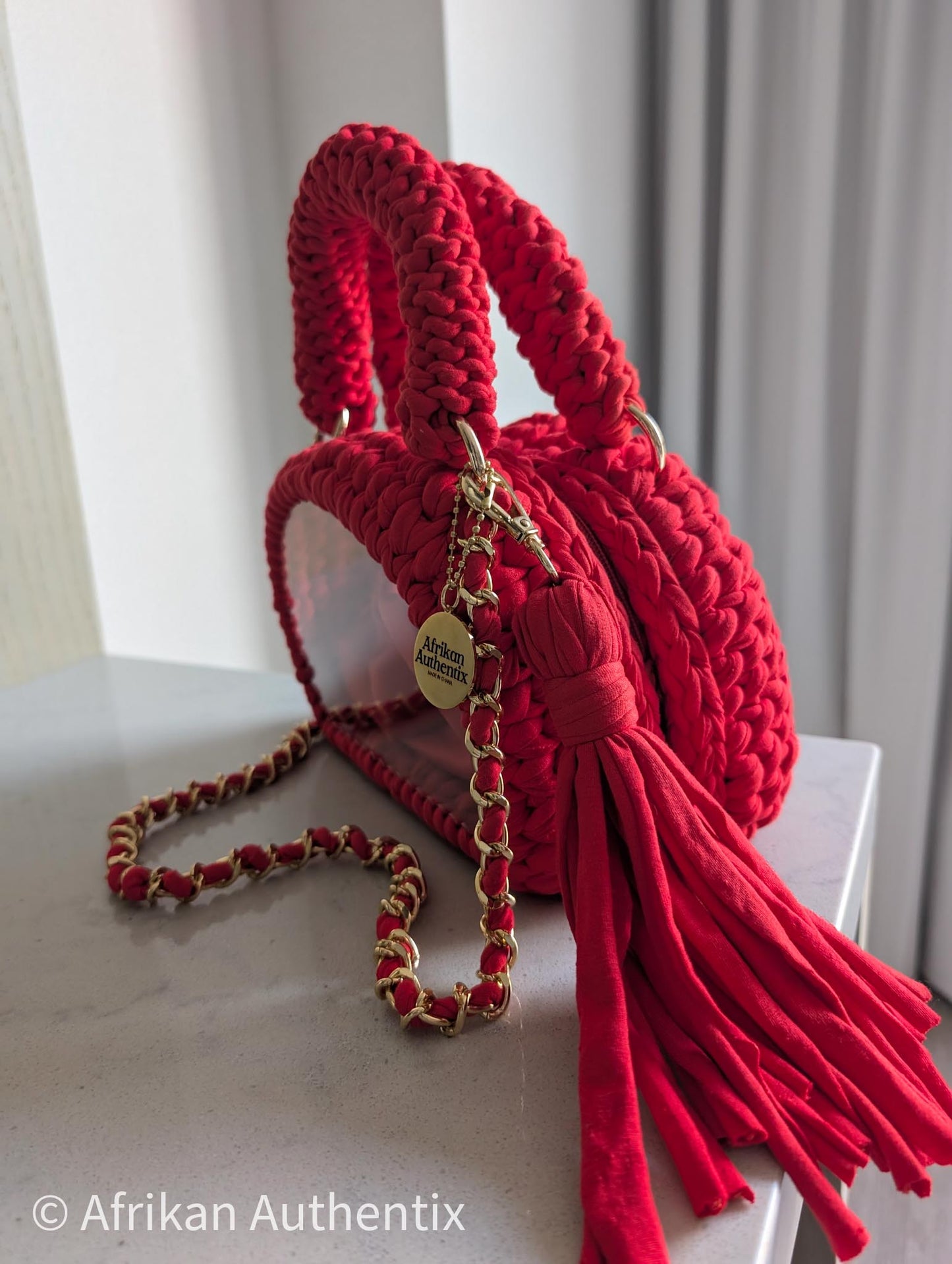 Red crochet mini handbag with gold chain strap and clear window by Afrikan Authentix

