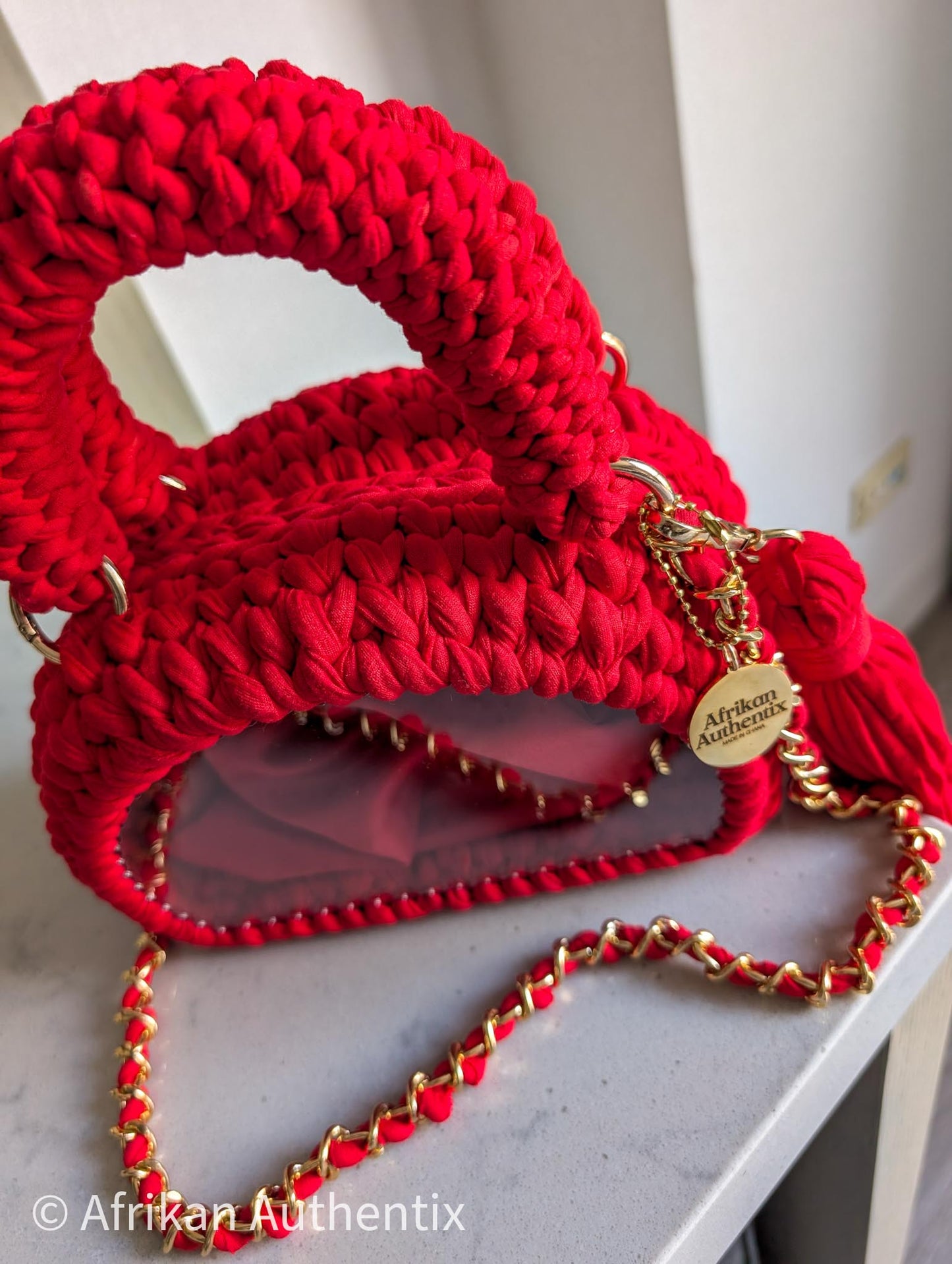 Red crochet mini handbag with gold chain strap and clear window by Afrikan Authentix
