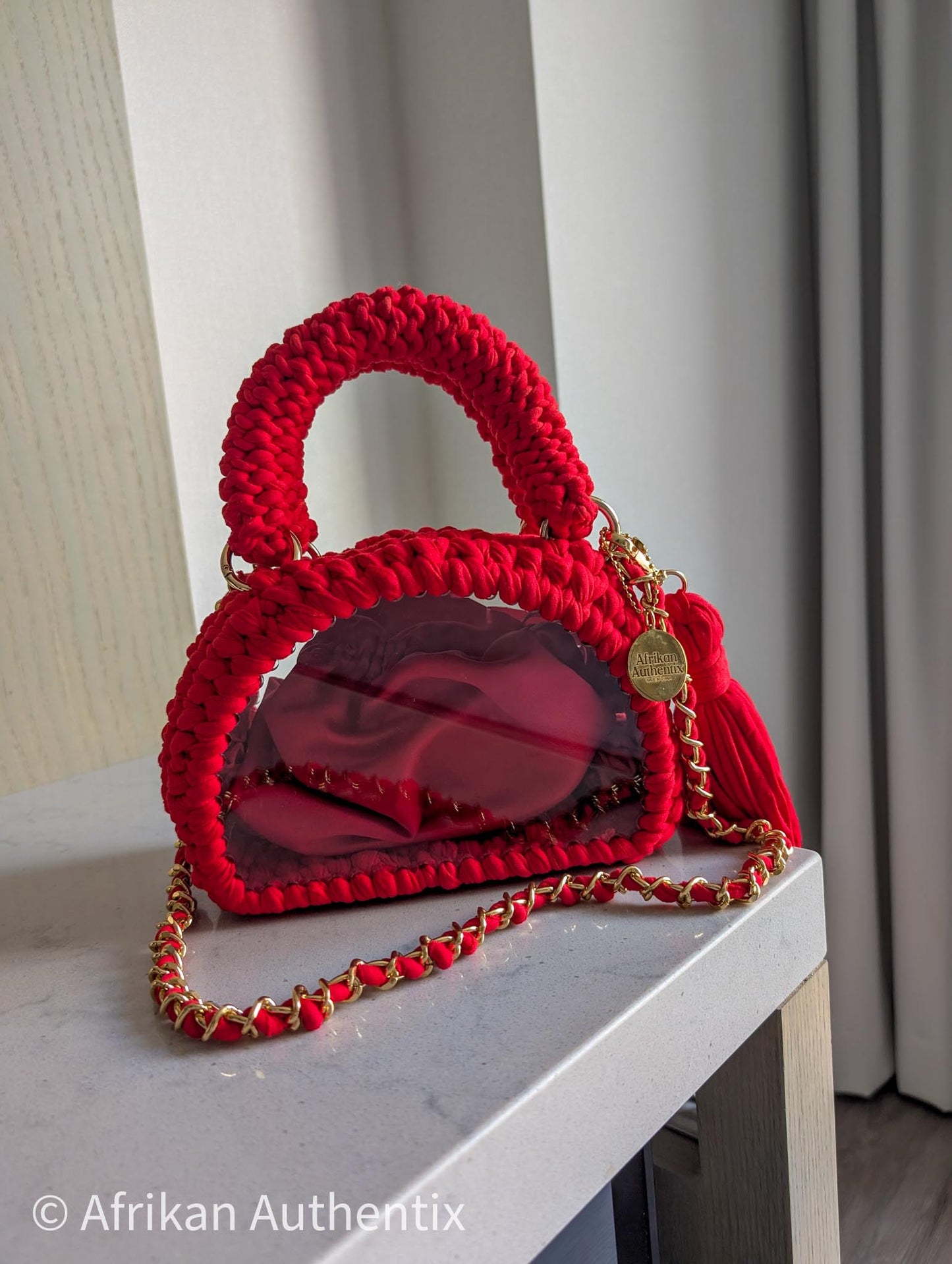 Red crochet mini handbag with gold chain strap and clear window by Afrikan Authentix
