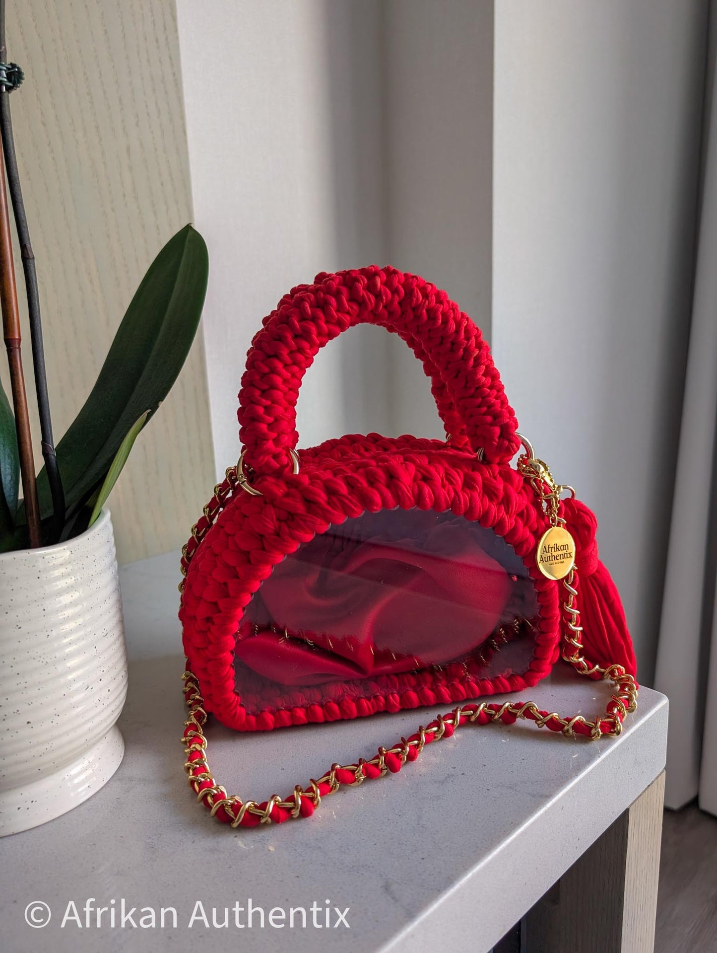 Red crochet mini handbag with gold chain strap and clear window by Afrikan Authentix
