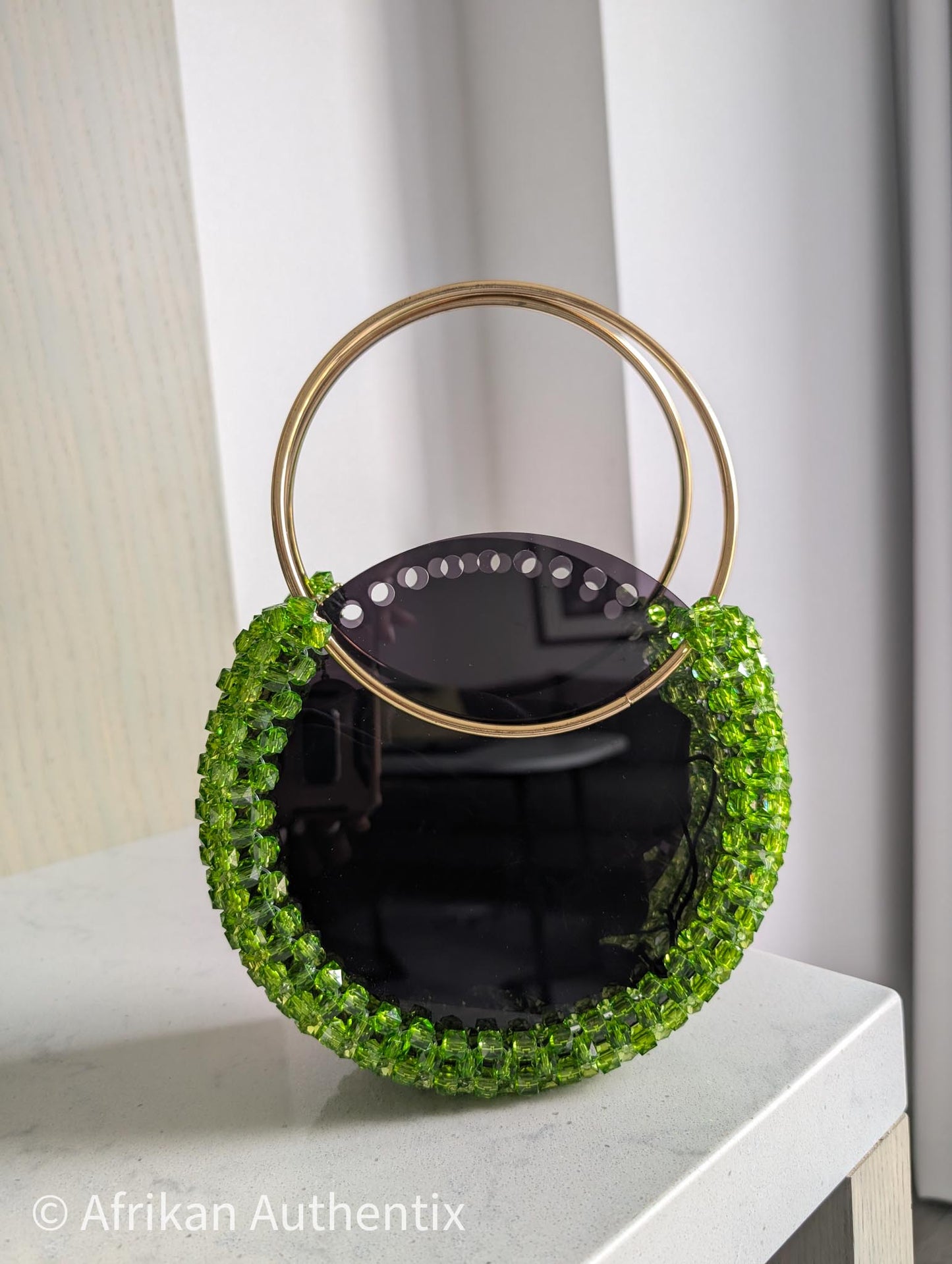 Green beaded round handbag with gold ring handle handmade in Ghana by Afrikan Authentix