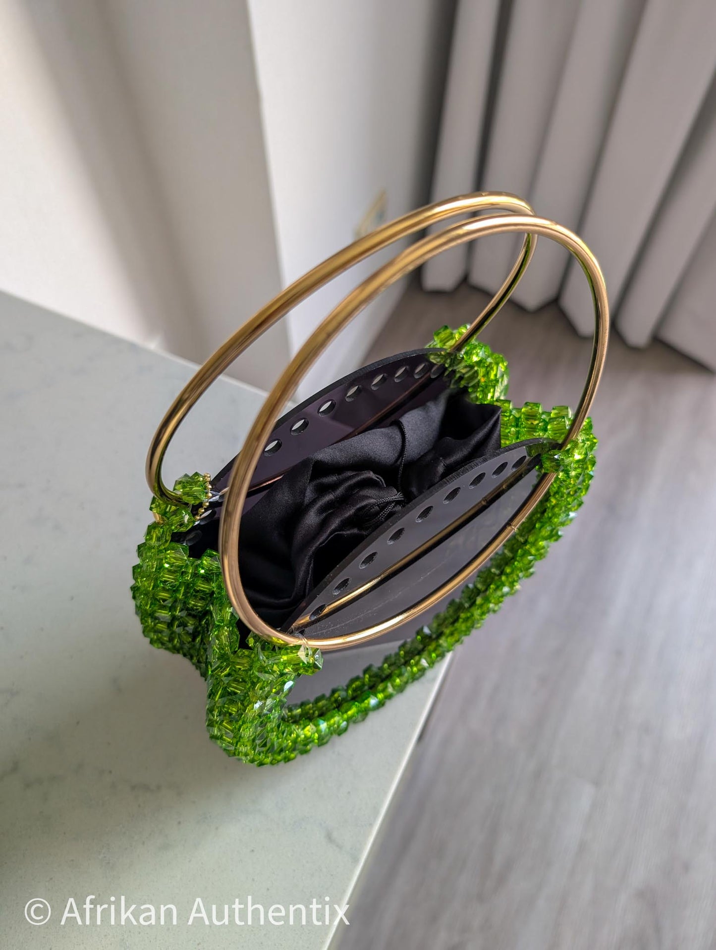 Green beaded round handbag with gold ring handle handmade in Ghana by Afrikan Authentix