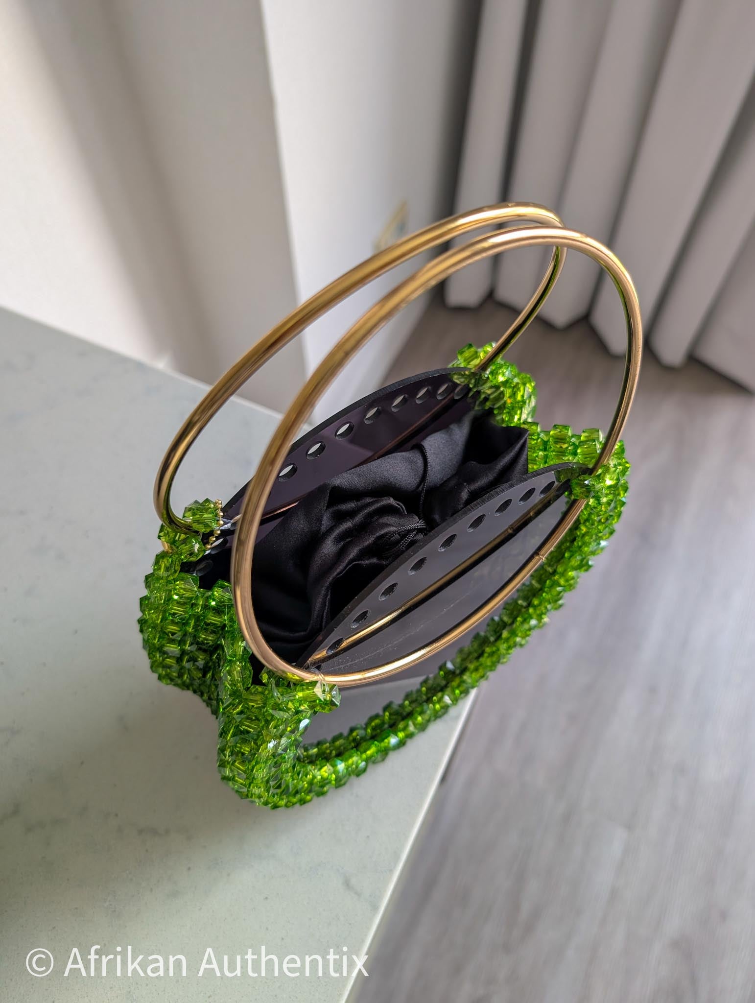 Green beaded round handbag with gold ring handle handmade in Ghana by Afrikan Authentix
