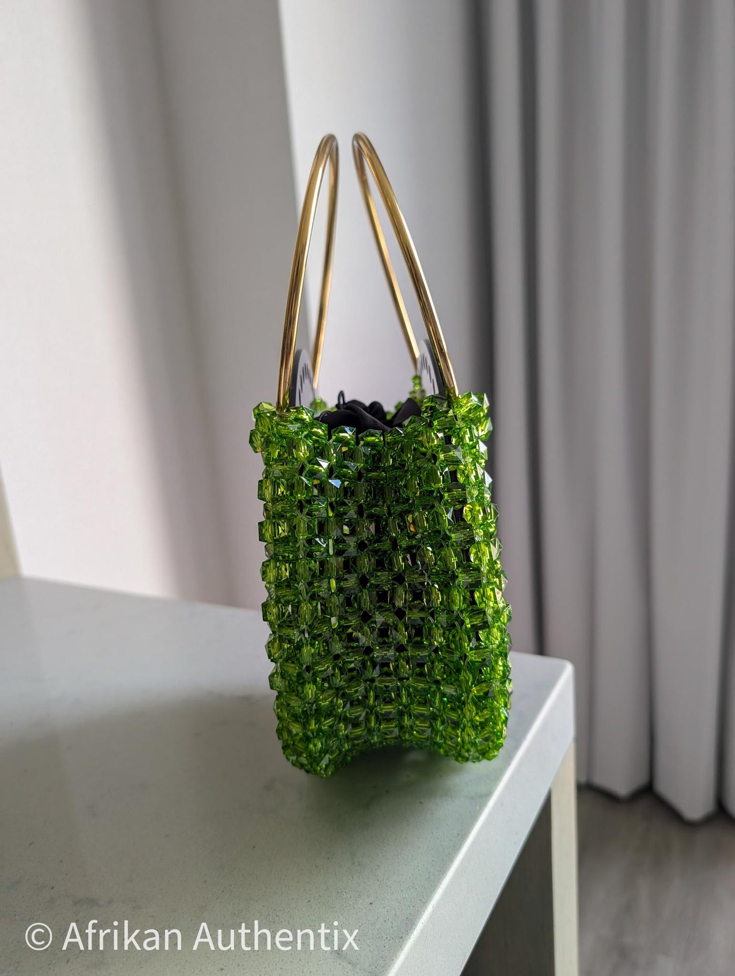 Green beaded round handbag with gold ring handle handmade in Ghana by Afrikan Authentix