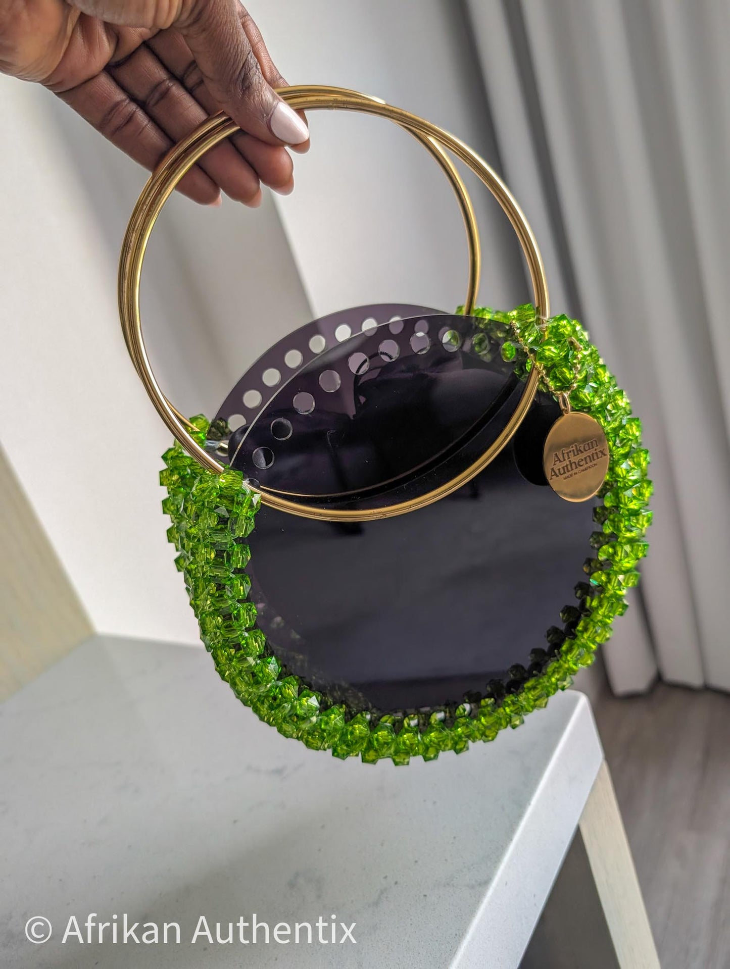 Green beaded round handbag with gold ring handle handmade in Ghana by Afrikan Authentix