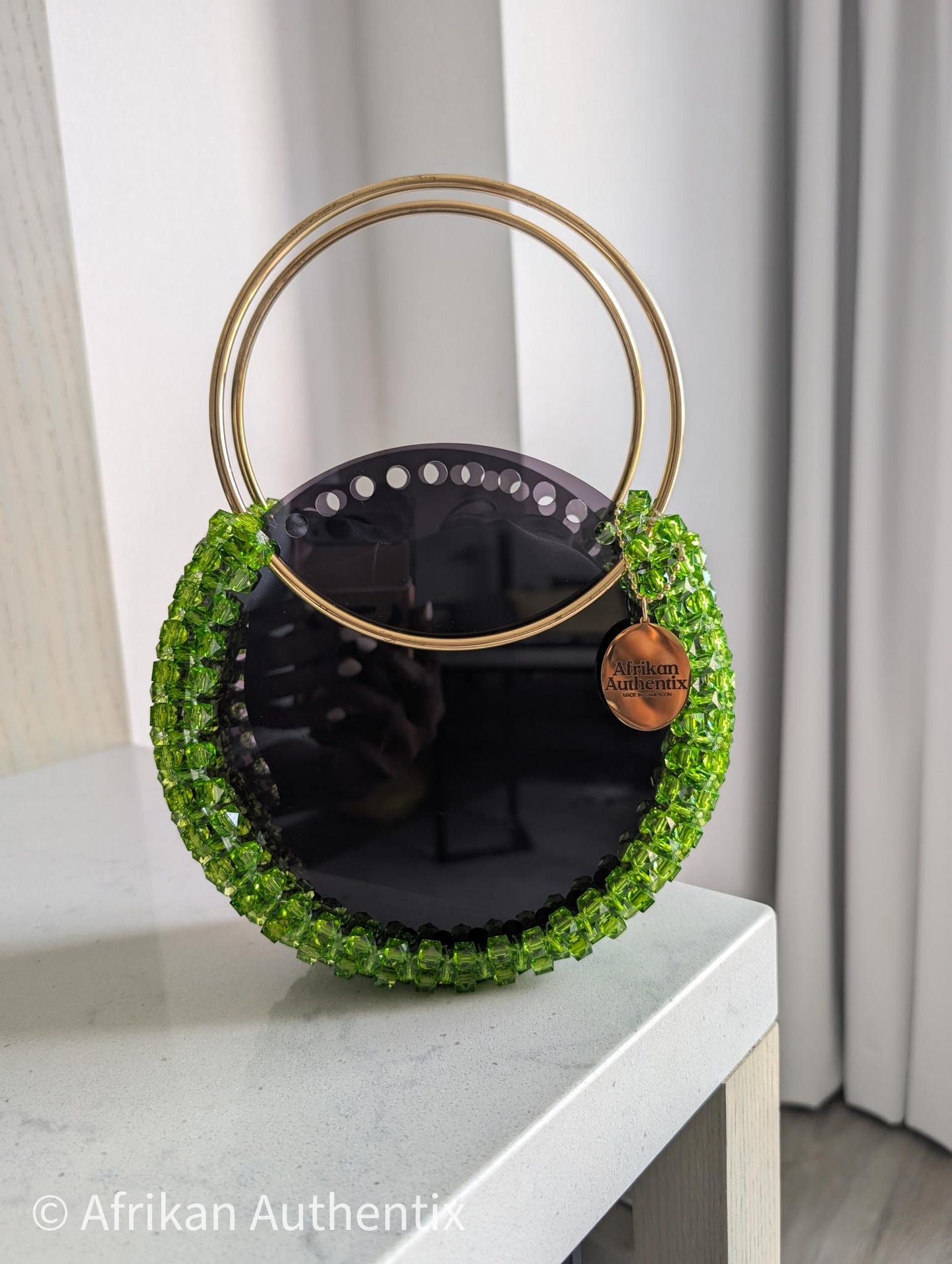 Green beaded round handbag with gold ring handle handmade in Ghana by Afrikan Authentix