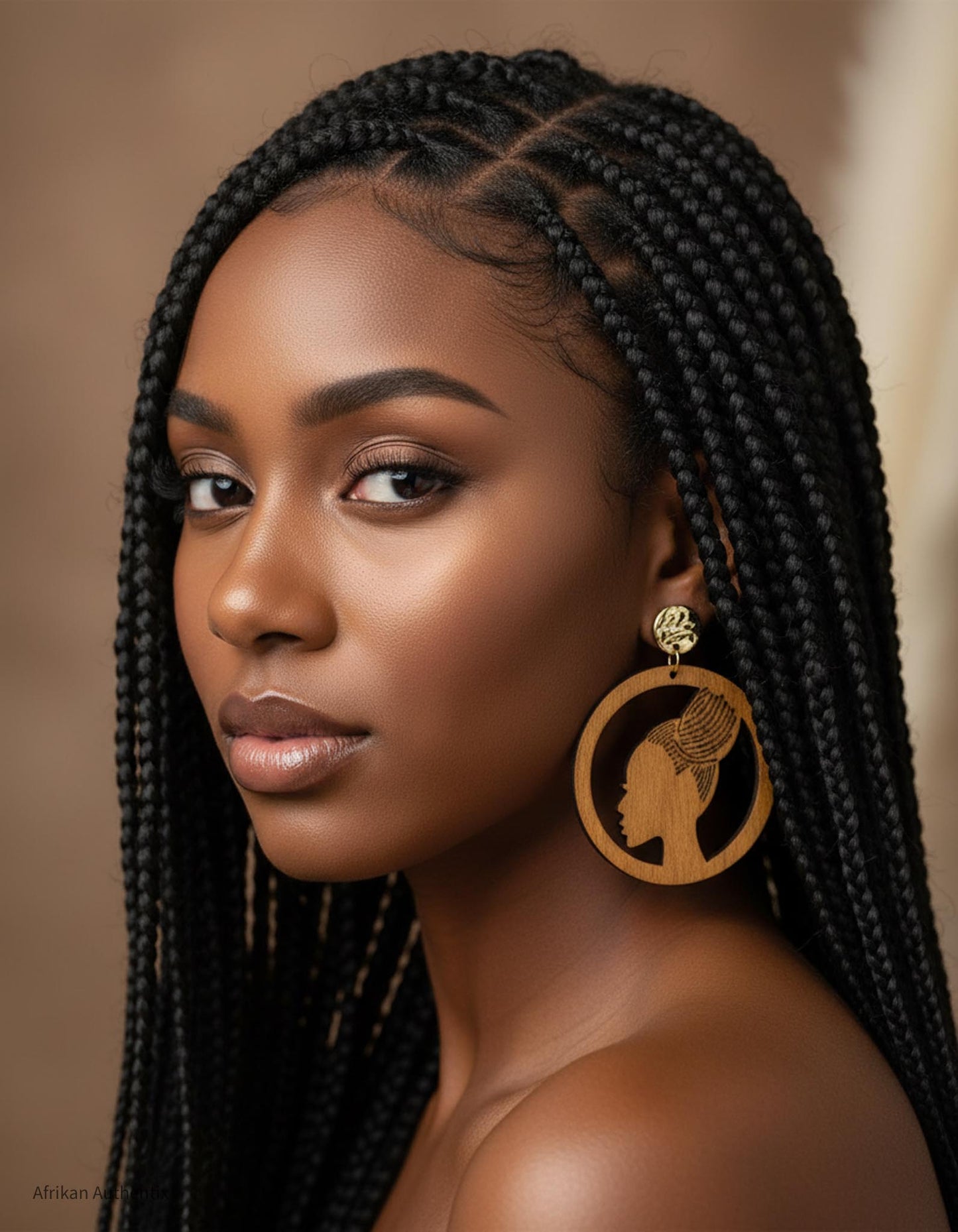 Woman with braided hair wearing a large, african woman silhouette wooden earrings  