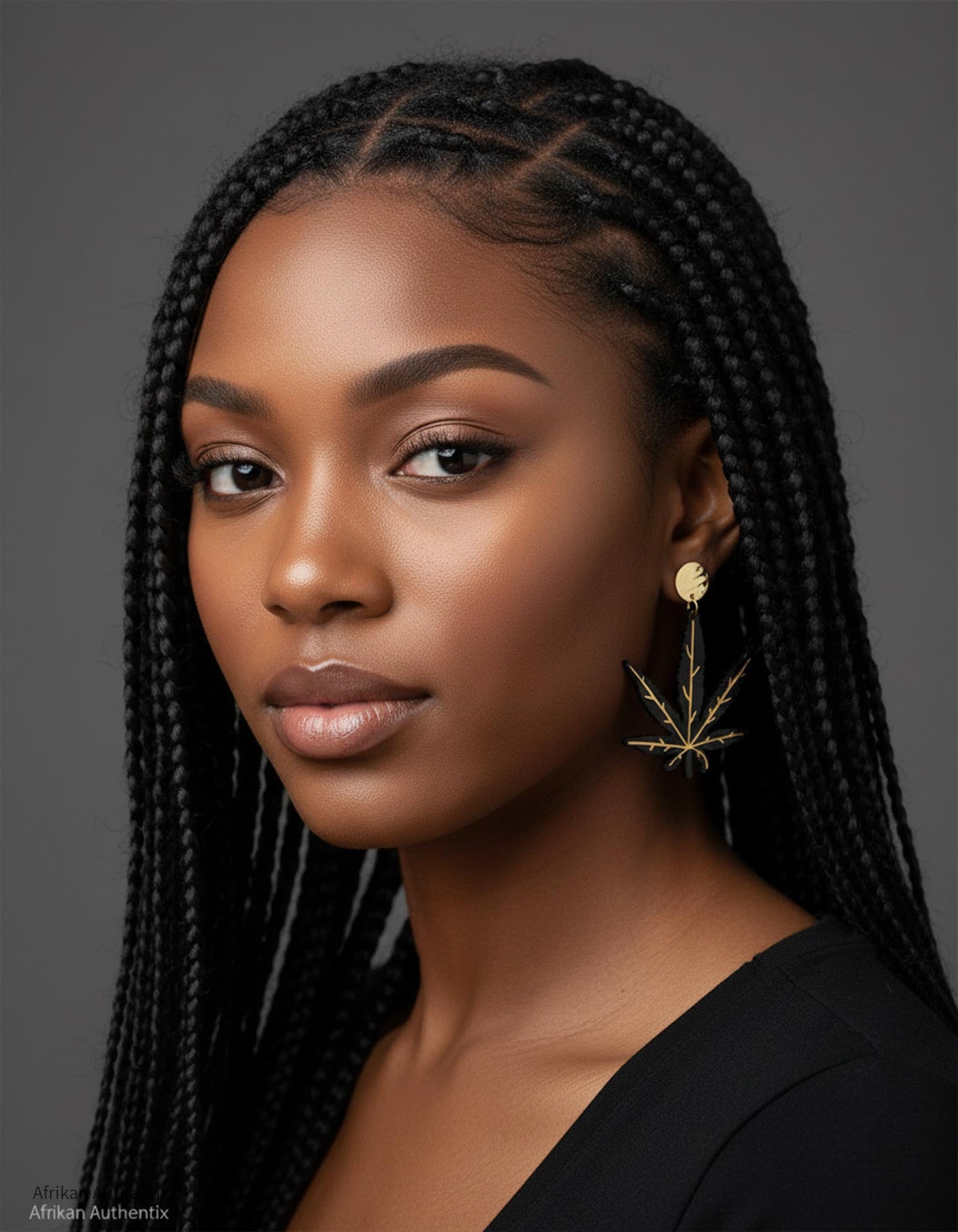 Woman with braided hair wearing black Hemp leaf wooden earrings