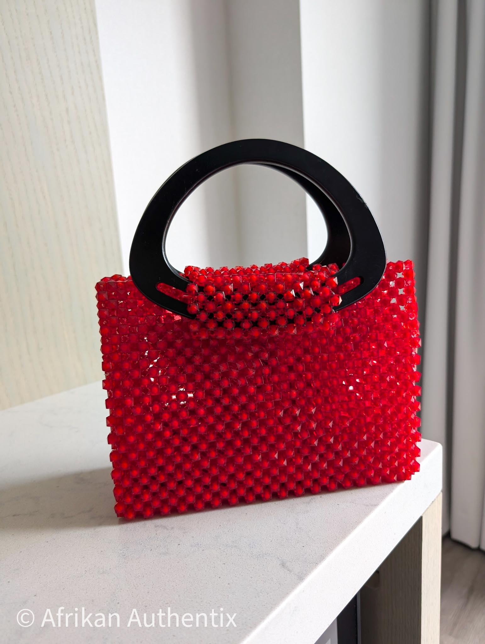 Red beaded square handbag with black wooden handle handmade in Ghana by Afrikan Authentix