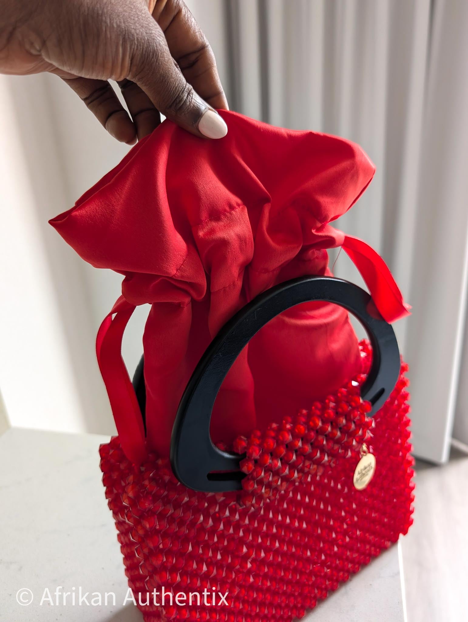 Red beaded square handbag with black wooden handle handmade in Ghana by Afrikan Authentix