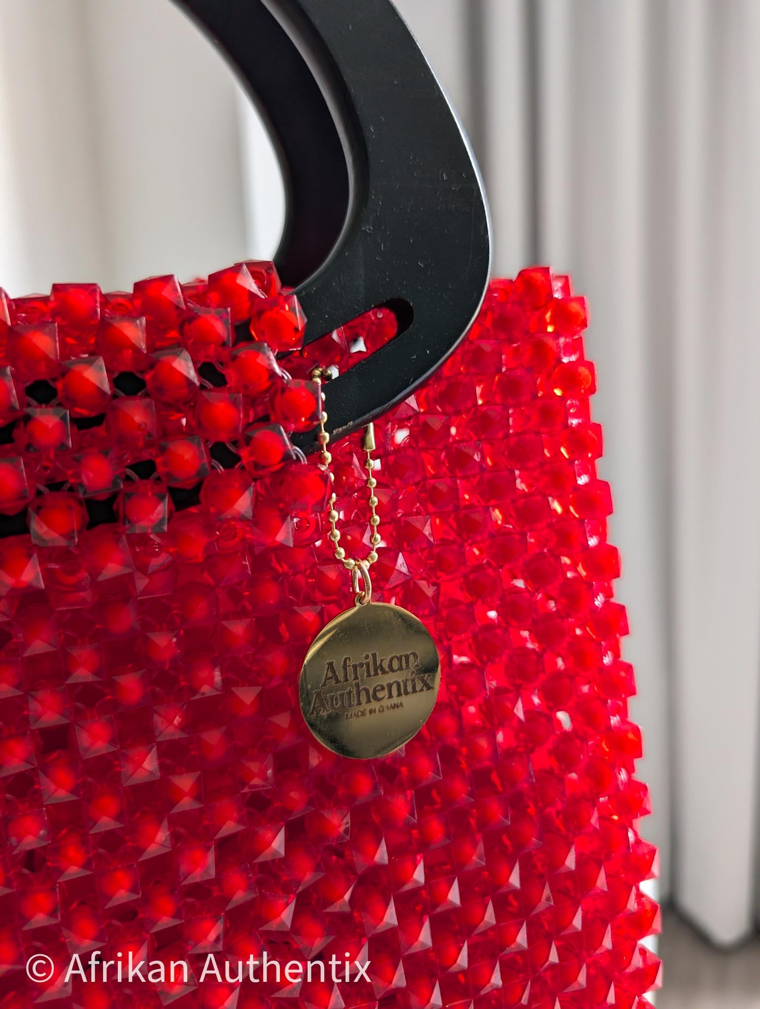 Red beaded square handbag with black wooden handle handmade in Ghana by Afrikan Authentix