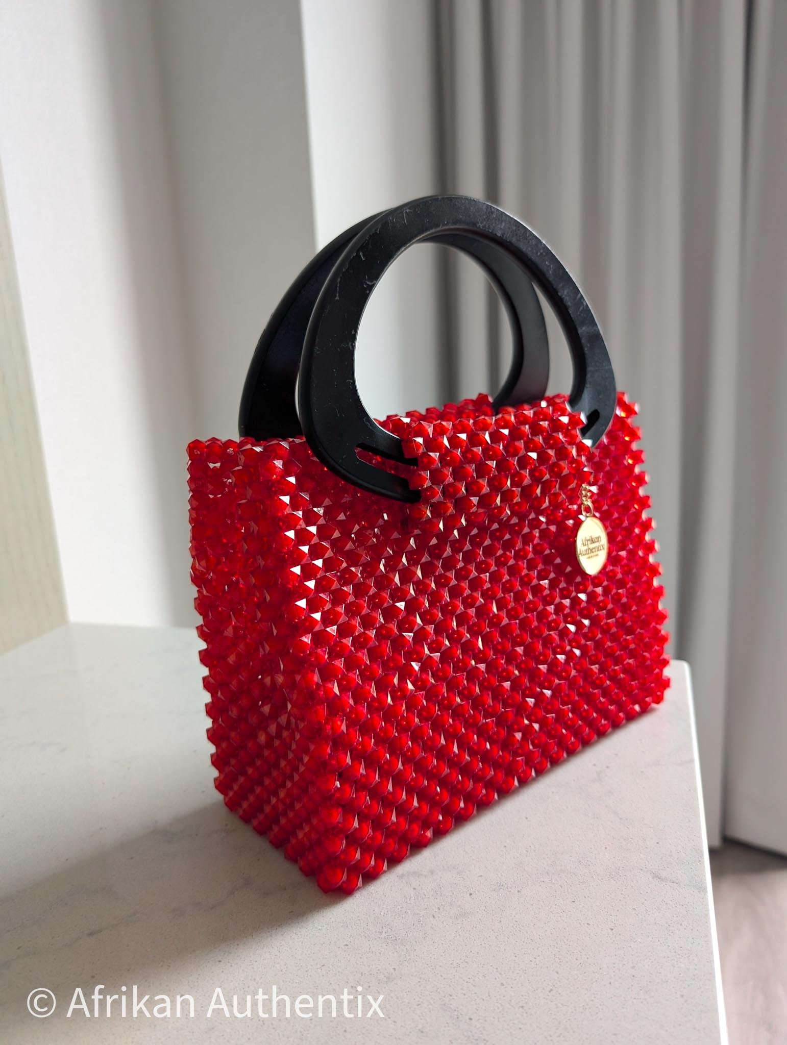 Red beaded square handbag with black wooden handle handmade in Ghana by Afrikan Authentix
