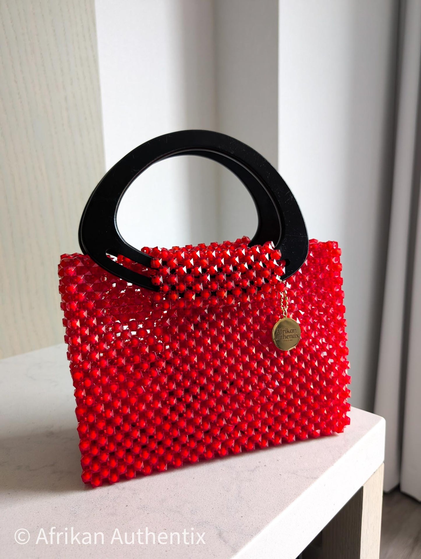 Red beaded square handbag with black wooden handle handmade in Ghana by Afrikan Authentix
