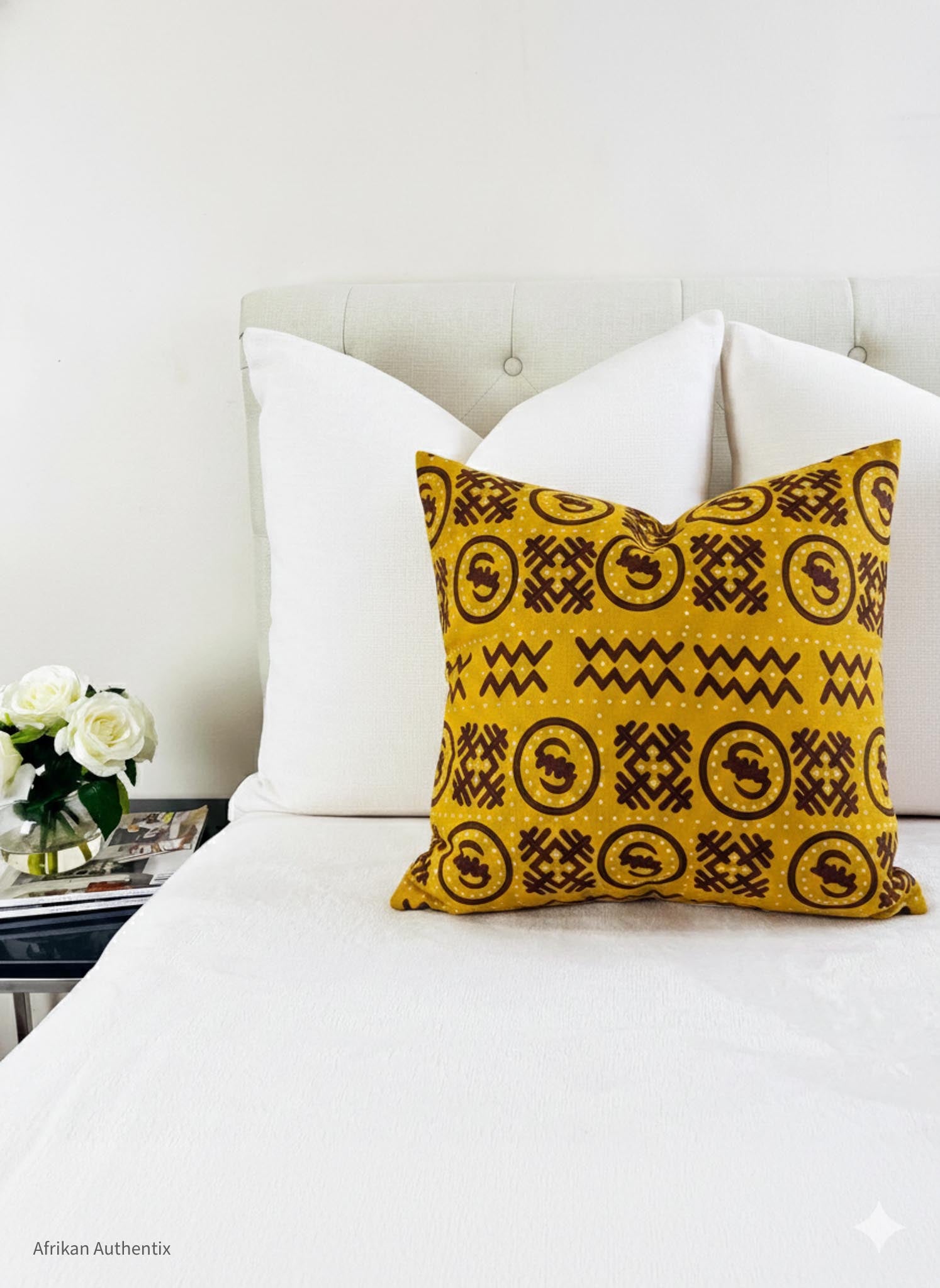 Handmade yellow African print pillow cover with Adinkra symbols