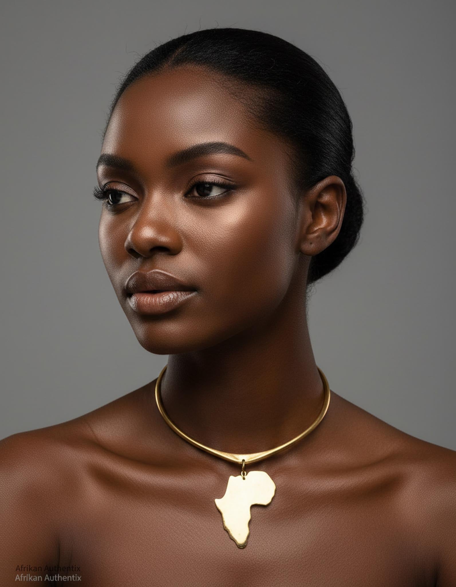 Woman wearing a gold necklace with an African continent pendant against a gray background
